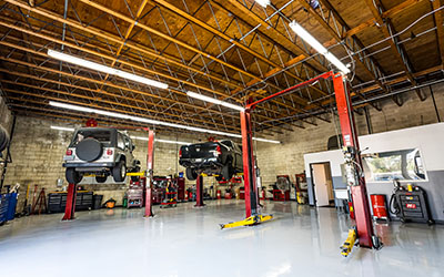 Precision Automotive service bays with vehicles on lifts